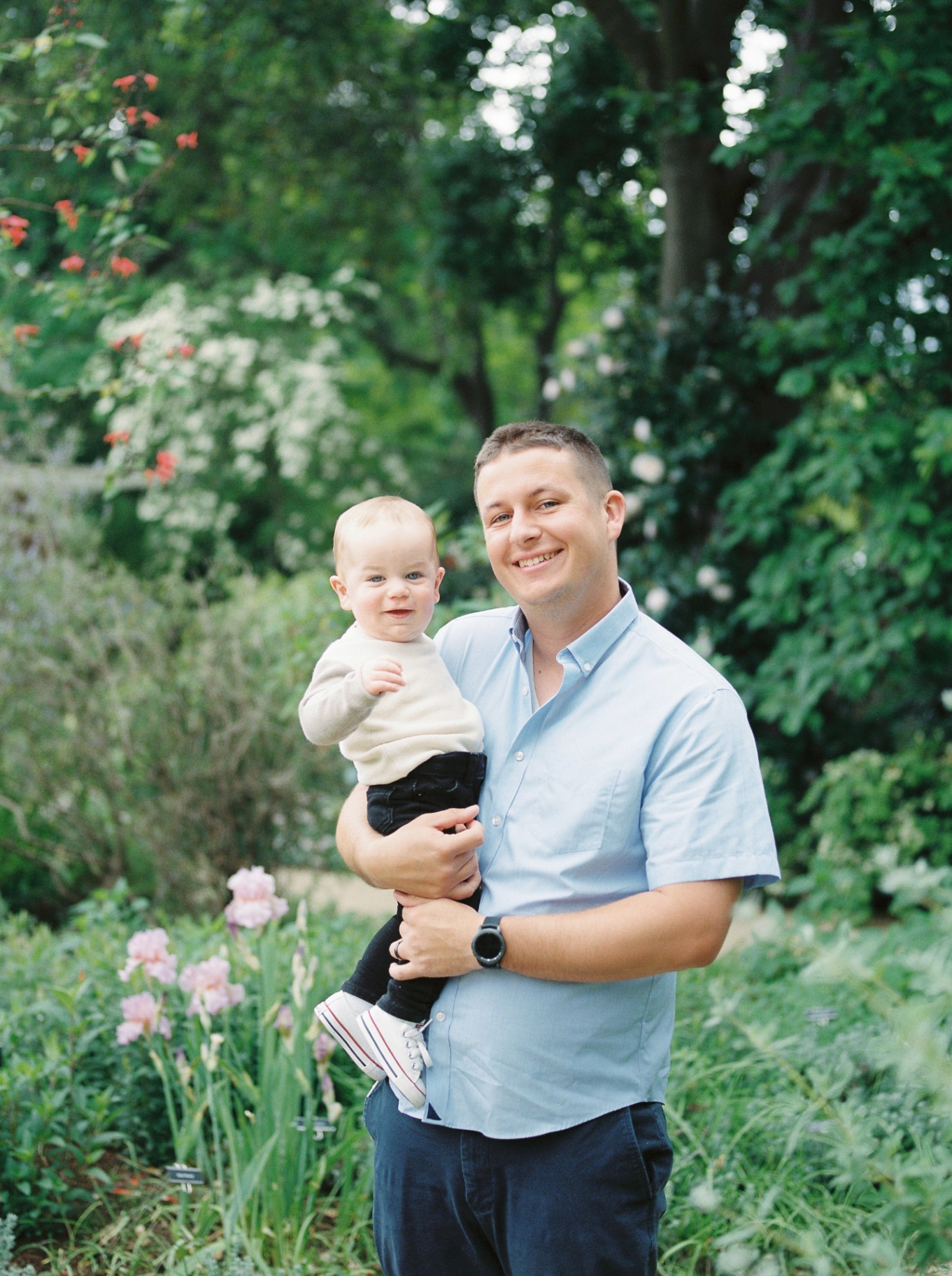 Steven, co-founder of Before Baby and licensed Bay Area paramedic, holding his young son outdoors